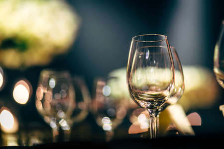 Luxury table settings for fine dining with and glassware, beautiful blurred  background. Preparation for holiday  Christmas and Hannukah dinner night.の写真素材