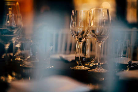 Luxury table settings for fine dining with and glassware, beautiful blurred  background. Preparation for holiday  Christmas and Hannukah dinner night.の写真素材