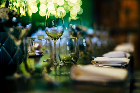 Luxury table settings for fine dining with and glassware, beautiful blurred  background. Preparation for holiday  Christmas and Hannukah dinner night.の写真素材