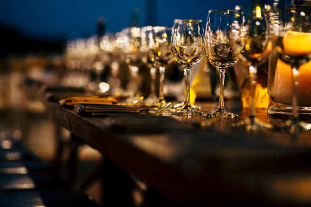 Luxury table settings for fine dining with and glassware, beautiful blurred  background. Preparation for holiday  Christmas and Hannukah dinner night.の写真素材