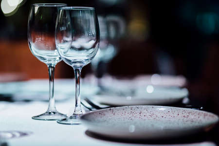 Luxury table settings for fine dining with and glassware, beautiful blurred  background. For events, weddings.の写真素材