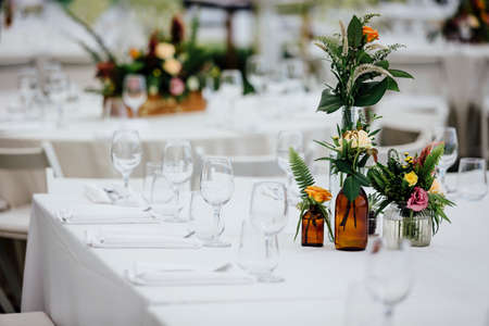 Luxury table settings for fine dining with and glassware, beautiful blurred  background. For events, weddings.の写真素材