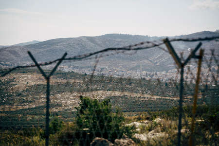 Razor wire fence in daylight view. International boarder between two countries.の写真素材
