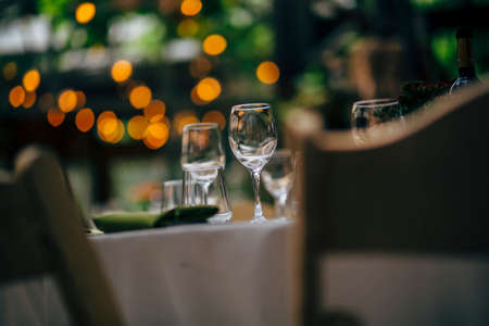Luxury table settings for fine dining with and glassware, beautiful blurred  background. For events, weddings and other social events.の写真素材