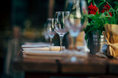 Luxury table settings for fine dining with and glassware, beautiful blurred  background. For events, weddings and other social events.の写真素材