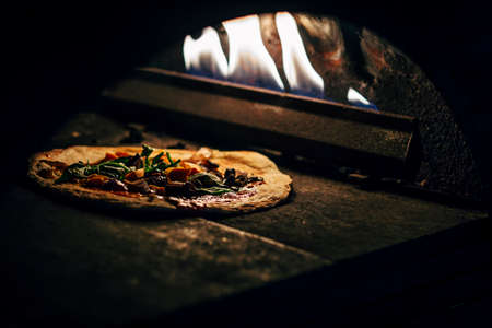 Preparation of a pizza in oven.の写真素材