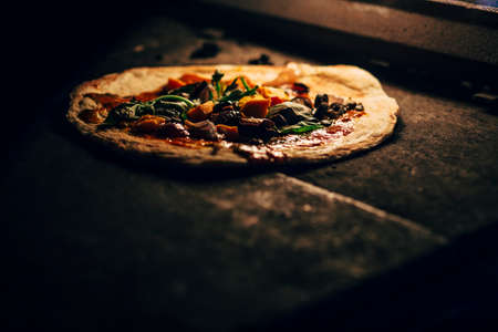 Preparation of a pizza in oven.の写真素材