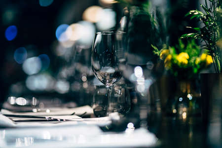 Luxury table settings for fine dining with and glassware, beautiful blurred  background. For events, weddings.の写真素材