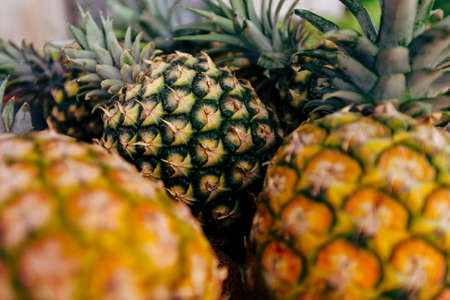Closeup on a fresh pineapple on wooden background.の写真素材
