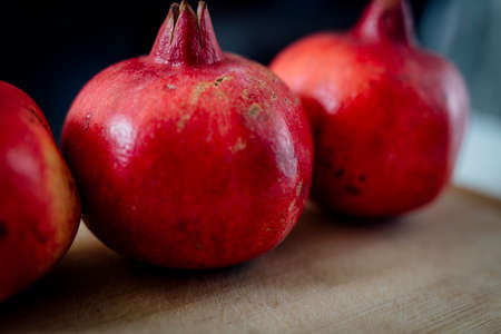 Fresh POMEGRANATE on wooden background.の写真素材
