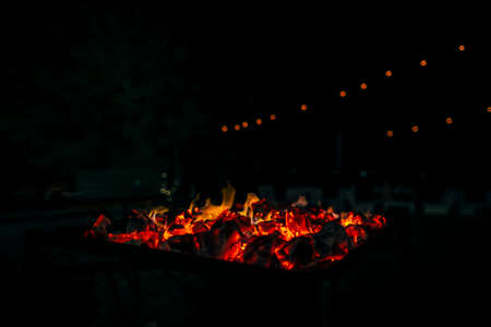 Night scene of fire sparks and flame burning with beautiful red flame.の写真素材