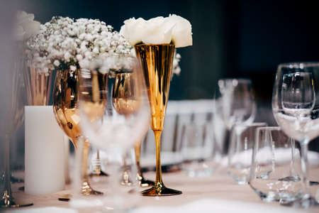 Luxury table settings for fine dining with and glassware, beautiful blurred  background. For events, weddings.  Preparation for holiday  Christmas and Hanukkah dinner night. props for weddings, birthdays, and celebrations.の写真素材