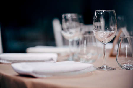 Luxury table settings for fine dining with and glassware, beautiful blurred  background. For events, weddings.  Preparation for holiday  Christmas and Hanukkah dinner night. props for weddings, birthdays, and celebrations.の写真素材