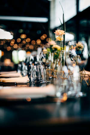 Luxury table settings for fine dining with and glassware, beautiful blurred  background. For events,...