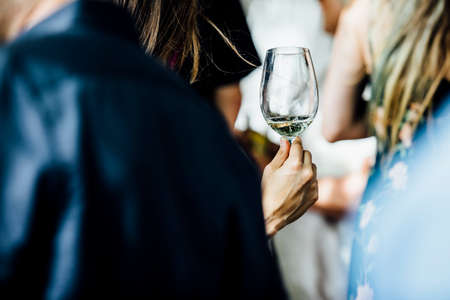 Man and woman are holding and pouring wine at social events and weddings.の写真素材