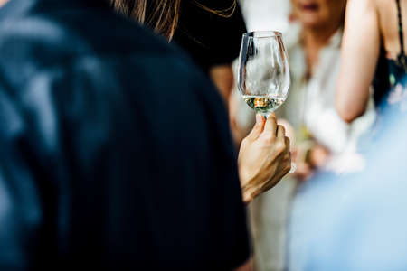 Man and woman are holding and pouring wine at social events and weddings.の写真素材