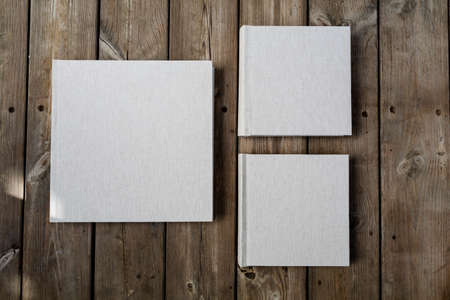 Wedding albums on beautiful wood background. Cloth cover without names. Can be used as design element. Set of albums. wedding, albums, books,の写真素材