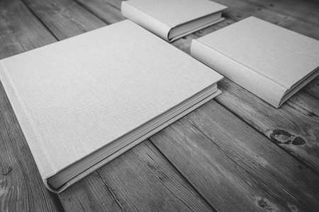 Wedding albums on beautiful wood background. Cloth cover without names. Can be used as design element. Set of albums. wedding, albums, books,の写真素材