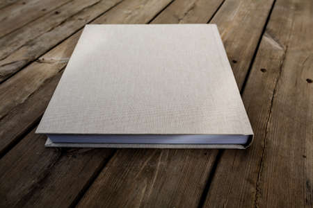 Wedding albums on beautiful wood background. Cloth cover without names. Can be used as design element. Set of albums. wedding, albums, books,の写真素材