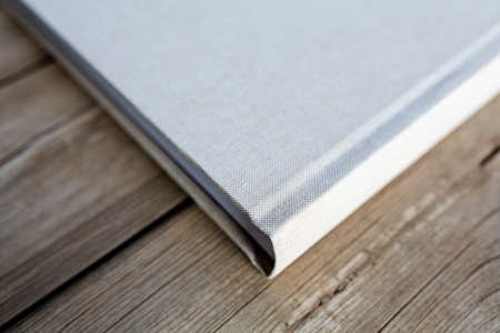 Wedding albums on beautiful wood background. Cloth cover without names. Can be used as design...
