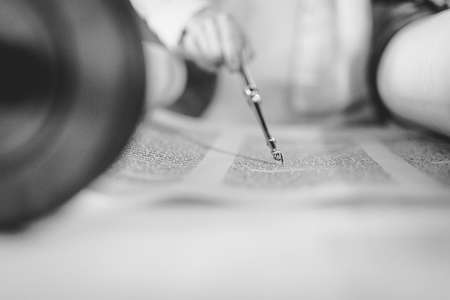 Aliyah to torah. Man in the temple celebration of bar mitzvah man is reading in the book of Tora. The tfilin is on his hands. synagogue, also called a shul or temple, is a Jewish house of worship.の写真素材