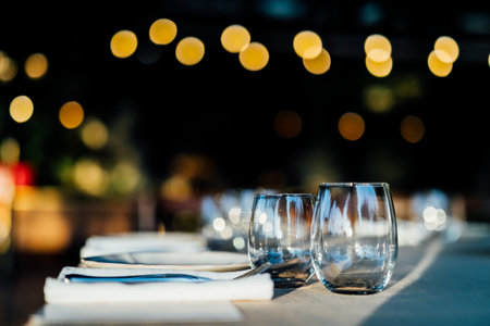 Luxury table settings for fine dining with and glassware, beautiful blurred background. Preparation for holiday Christmas and Hannukah dinner night.の写真素材