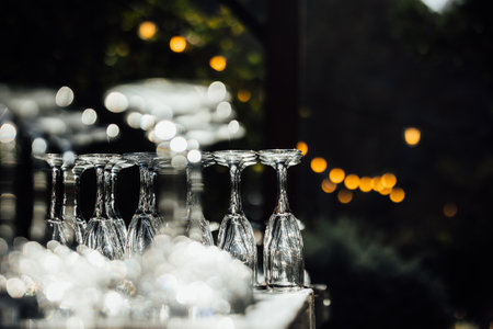 Wine glasses on the table with bokeh lights background.の写真素材