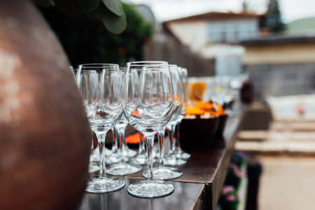 Luxury table settings for fine dining with and glassware, pouring wine to glass. Beautiful blurred background. Preparation for holiday wedding. Fancy luxury restaurant.の写真素材