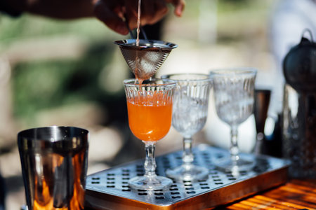 Luxury table settings for fine dining with and glassware, pouring wine to glass. Beautiful blurred...