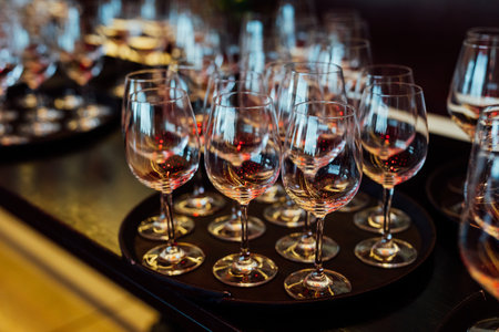 Luxury table settings for fine dining with and glassware, pouring wine to glass. Beautiful blurred...