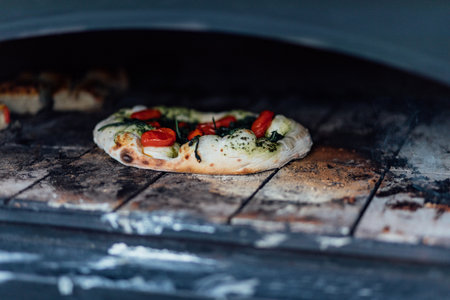 Baking and serving pitta brad, pizza and fresh bread in dinner restaurant and social events.