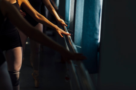 Ballerina Ballet dancer practicing dance in a studio with natural light and shadows.の写真素材