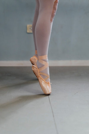 Ballerina Ballet dancer practicing dance in a studio with natural light and shadows.の写真素材