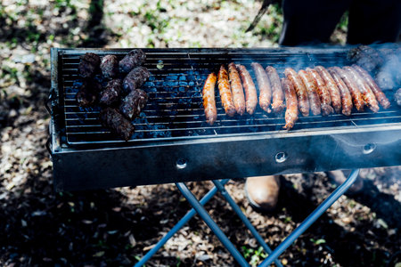 Juicy smoked beef brisket being freshly sliced on a wooden cutting board during a barbecue event. Close-up of tender meat with a charred crust, captured in natural light for a rustic and authentic culinary feel.âの写真素材