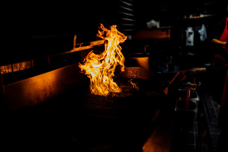 Juicy smoked beef brisket being freshly sliced on a wooden cutting board during a barbecue event. Close-up of tender meat with a charred crust, captured in natural light for a rustic and authentic culinary feel.âの写真素材