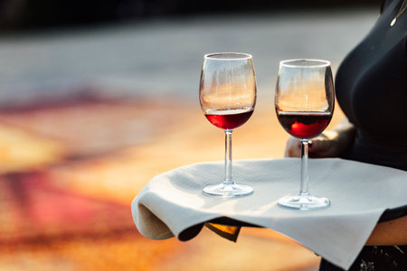 An elegant table setting with cutlery, wine glasses, and white napkins, illuminated by soft natural light. Perfect for interior design, events, or hospitality concepts.の写真素材