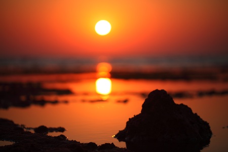 beautiful sun going up to give the miracle colours for low tide in Red seaの写真素材