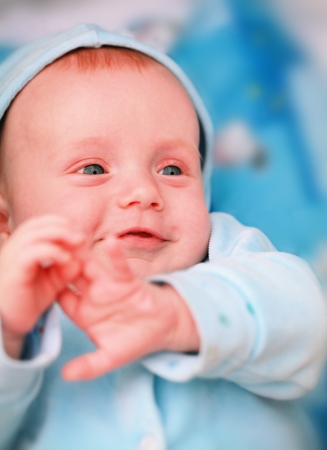 Smiling baby boy with big blue eyes close up の写真素材