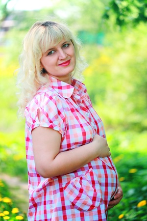 beautiful young pregnant woman outdoorsの写真素材