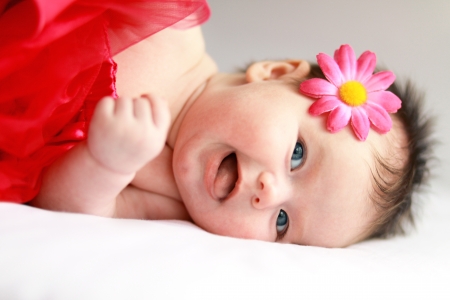 Smiling baby girl with big blue eyes close upの写真素材