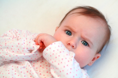 sad baby girl looking at camera close upの写真素材