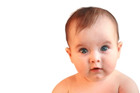 Cute baby girl lookingin in wide-eyed astonishment close upの写真素材