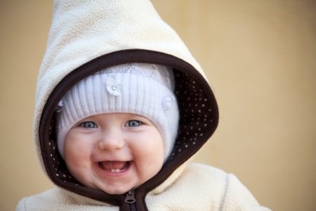laughing cute baby girl  outside looking at camera close upの写真素材