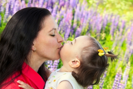young mother kissing her little daughterの写真素材