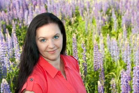 beautiful young woman smiling on meadow in summer dayの写真素材