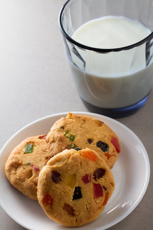 Homemade cookies on a white saucer and a glass of milk. Close-up.の写真素材