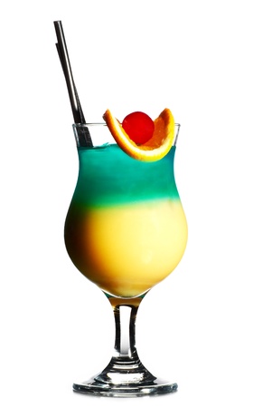 Colorful fresh cocktail in glass decorated with piece of orange and red cherry isolated on whiteの写真素材
