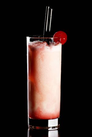 Fresh  drink in a shot glass decorated with cherryの写真素材