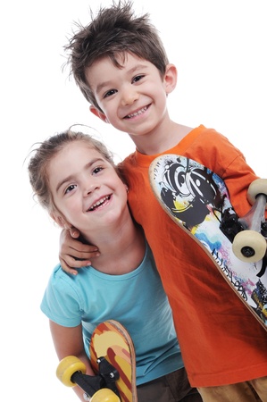 Photography of cute boy and girl are carring skate boards  close up  in  studio shot の写真素材