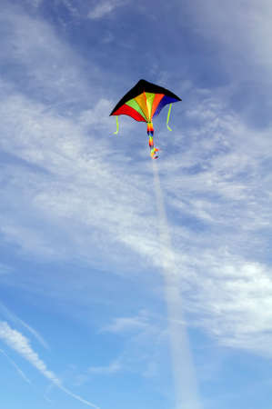 colorful kites flying against the blue sky and white cloudsの写真素材